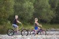 Cute young blond children, boy and girl riding child bicycles on Royalty Free Stock Photo