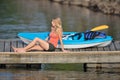 Cute young blonde woman - kayaking at lake Royalty Free Stock Photo