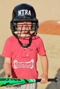 Cute young boy in a baseball helmet holding a bat