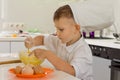 Cute young boy chef whipping the eggs Royalty Free Stock Photo