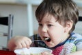 cute young boy eating healthy oatmeal for breakfast Royalty Free Stock Photo