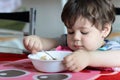 cute young boy eating healthy oatmeal for breakfast Royalty Free Stock Photo