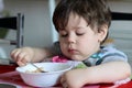 cute young boy eating healthy oatmeal for breakfast Royalty Free Stock Photo