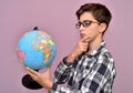 Young boy holding and examining the globe Royalty Free Stock Photo