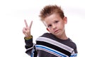 Cute young boy holding up the peace sign