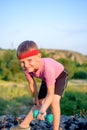 Cute Young Boy Lifting Dumbbell on Top of Boulder Royalty Free Stock Photo