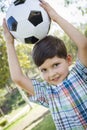 Cute Young Boy Playing with Soccer Ball in Park Royalty Free Stock Photo