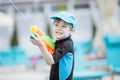 Young boy shooting water gun outdoors Royalty Free Stock Photo