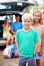 Cute young boy smiling. Portrait of young brother and sister smiling with parents sitting in the car. Royalty Free Stock Photo