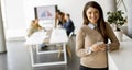 Young business woman standing in the office and using mobile phone in front of her team Royalty Free Stock Photo