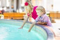 Cute Young Caucasian Brother and Sister Enjoying a Fountain