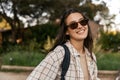 Cute young caucasian girl smiles with her teeth looking at camera spending time in nature. Royalty Free Stock Photo