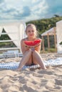 Cute young child eating watermelon on the beach Royalty Free Stock Photo