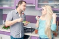 Cute young couple eating fresh vegetable salad Royalty Free Stock Photo