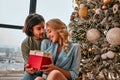 Cute, young couple exchanging Christmas presents on Christmas morning. Close up view Royalty Free Stock Photo