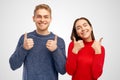 Cute young couple girl and man having fun smiling and showing the thumbs up sign. Sign of consent fun and approval. Royalty Free Stock Photo