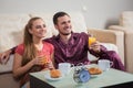 Cute young couple having breakfast, eating croissants, drinking orange juice. Royalty Free Stock Photo