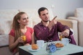 Cute young couple having breakfast, eating croissants, drinking orange juice. Royalty Free Stock Photo