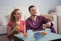 Cute young couple having breakfast, eating croissants, drinking orange juice. Royalty Free Stock Photo