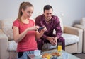 Cute young couple having breakfast, photographs at mobile phone Royalty Free Stock Photo