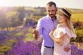 Cute young happy couple in love in a field of lavender flowers. Enjoy a moment of happiness and love in a lavender field.
