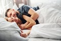 Cute young couple lying down on the bed and sleeping together Royalty Free Stock Photo