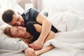 Cute young couple lying down on the bed and sleeping together Royalty Free Stock Photo