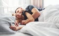 Cute young couple lying down on the bed and sleeping together Royalty Free Stock Photo