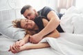 Cute young couple lying down on the bed and sleeping together Royalty Free Stock Photo