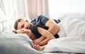 Cute young couple lying down on the bed and sleeping together Royalty Free Stock Photo