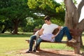 Cute young couple relaxing on bench. Royalty Free Stock Photo