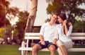 Cute young couple sitting at park Royalty Free Stock Photo