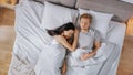 Cute Young Couple Sweetly Sleeping in the Bed, Girl Tenderly Cuddling and Emracing Her Boyfriend w Royalty Free Stock Photo