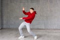 Cute young dancer posing on grey background. Royalty Free Stock Photo