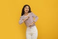 Cute young eastern lady dancing on yellow background Royalty Free Stock Photo