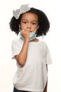 Cute Young Expressive African American Girl Wearing a Surgical Mask