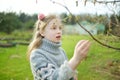 Cute young girl admiring fresh new soft buds sitting on chestnut tree branches Royalty Free Stock Photo