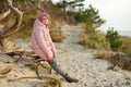 Cute young girl having fun at winter beach on cold winter day. Kids playing by the ocean Royalty Free Stock Photo