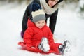 Cute young girl and her toddler brother having fun on a walk in snow covered pine forest on chilly winter day. Child exploring Royalty Free Stock Photo