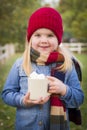Cute Young Girl Holding Cocoa Mug with Marsh Mallows Outside Royalty Free Stock Photo