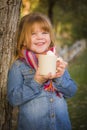 Cute Young Girl Holding Cocoa Mug with Marsh Mallows Outside Royalty Free Stock Photo