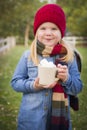 Cute Young Girl Holding Cocoa Mug with Marsh Mallows Outside Royalty Free Stock Photo