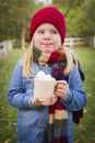 Cute Young Girl Holding Hot Cocoa Mug with Marshmallows Royalty Free Stock Photo