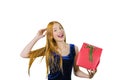 A cute young girl with long red hair holds in one hand a red box with a gift, while the other hand straightens her