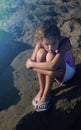 Cute young girl looking sad, alone, scared, abuse, homeless is sitting on the ground. Evening time. Nice sunlight. 3 Royalty Free Stock Photo