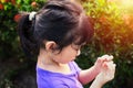 Girl picking flower petals in the garden Royalty Free Stock Photo