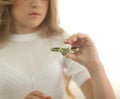 Cute young girl playing with green fidget spinner in bright room - closeup portrait Royalty Free Stock Photo