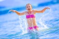 Cute young girl playing in the sea. Happy pre-teen girl enjoys summer water and holidays in holiday destinations Royalty Free Stock Photo