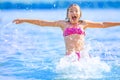 Cute young girl playing in the sea. Happy pre-teen girl enjoys summer water and holidays in holiday destinations Royalty Free Stock Photo