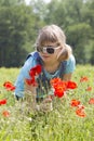 Cute young girl in poppy field Royalty Free Stock Photo